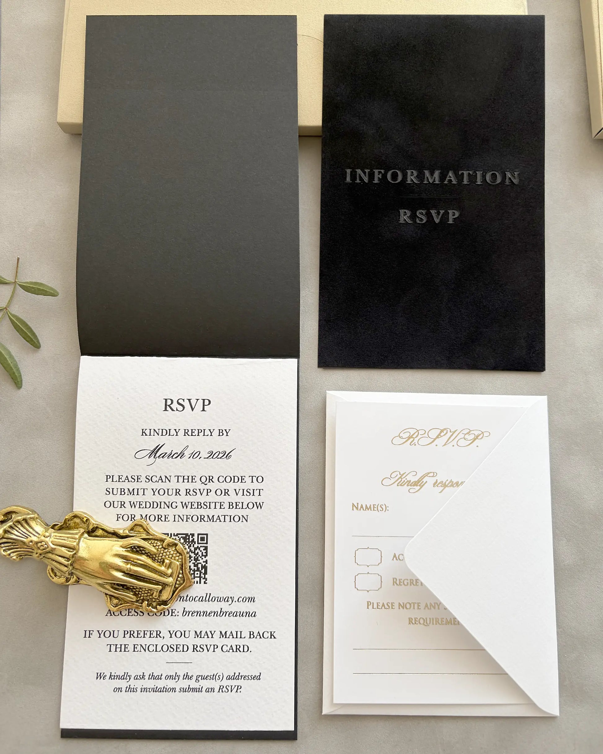 Black wedding invitation with floral design and initials on a black folio invite