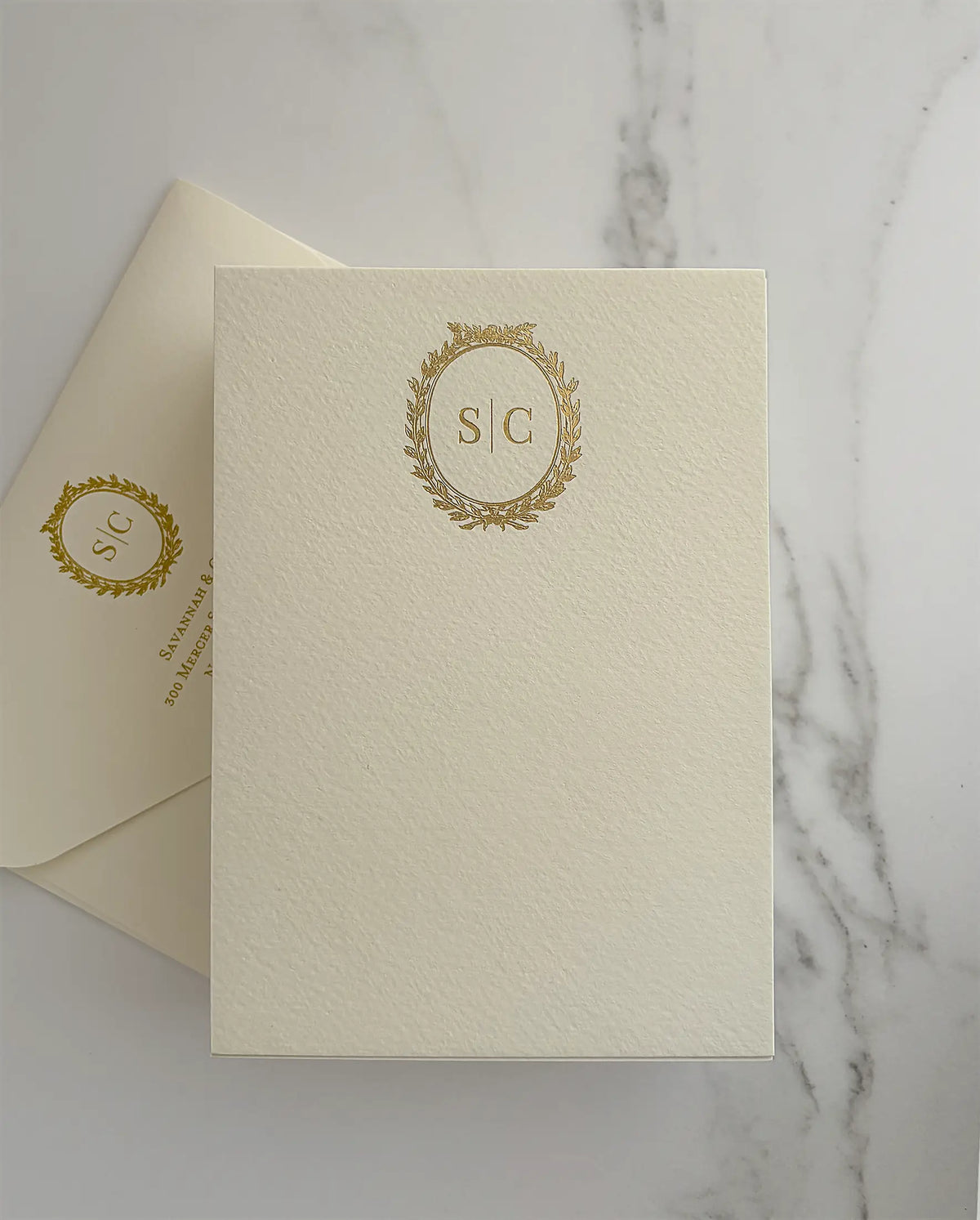 Cream A6 thank you card with a gold foil laurel wreath monogram and a matching envelope with foil monogram and return address — Polina Perri
