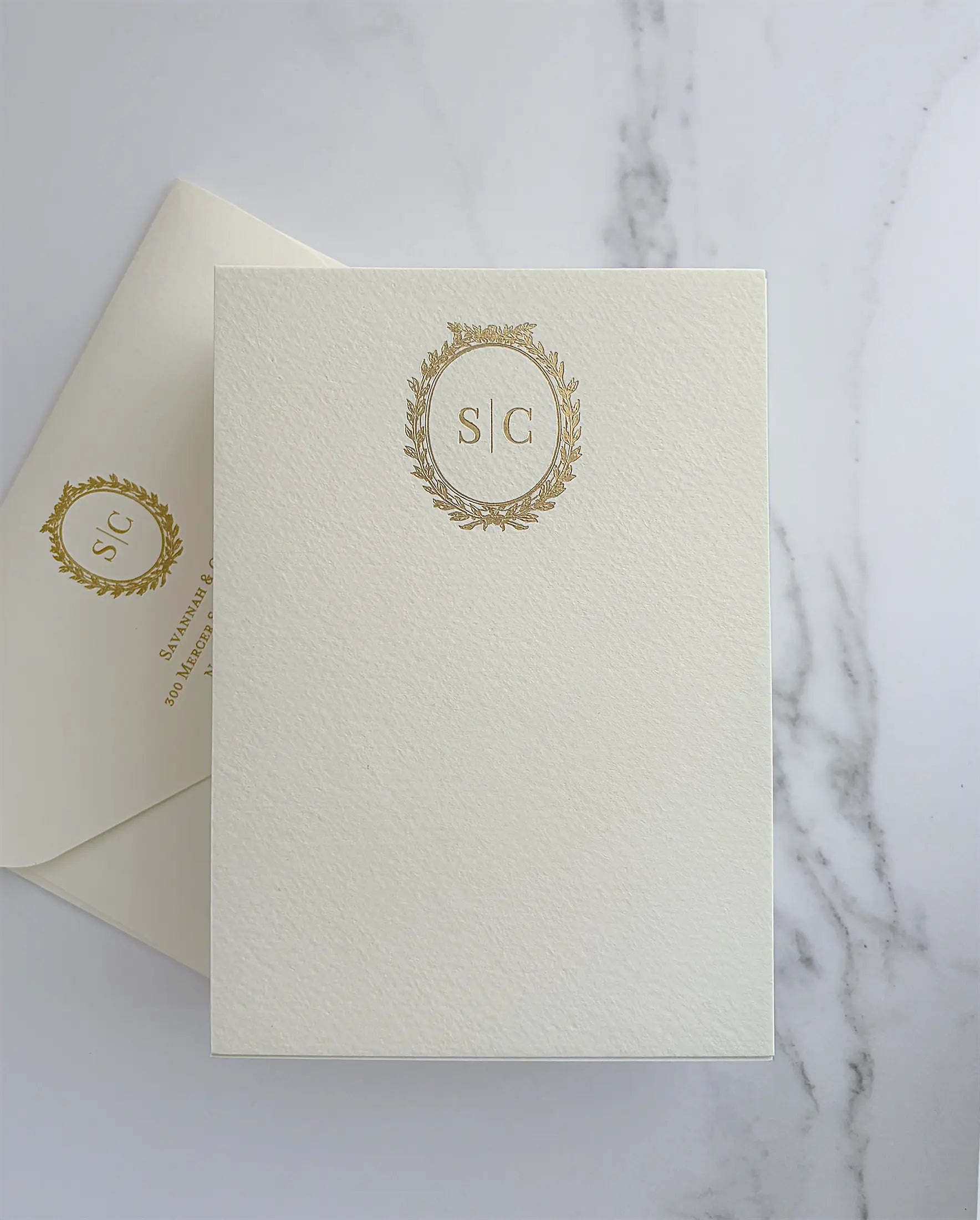 Cream A6 thank you card with a gold foil laurel wreath monogram and a matching envelope with foil monogram and return address — Polina Perri