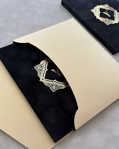Great Gatsby Folio Invitation in gold cardstock envelope with curved opening, revealing black velvet folder and gold foil Art Deco monogram — Polina Perri