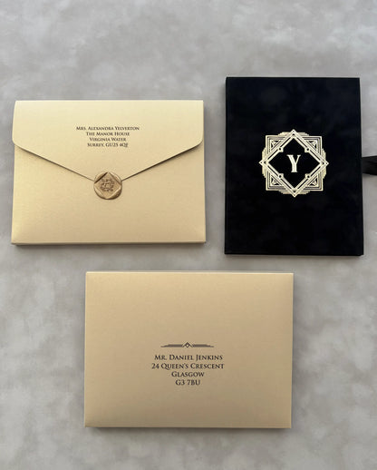 Great Gatsby Folio Invitation with gold cardstock envelopes, printed guest addressing, wax seal and black velvet folder with gold foil monogram — Polina Perri