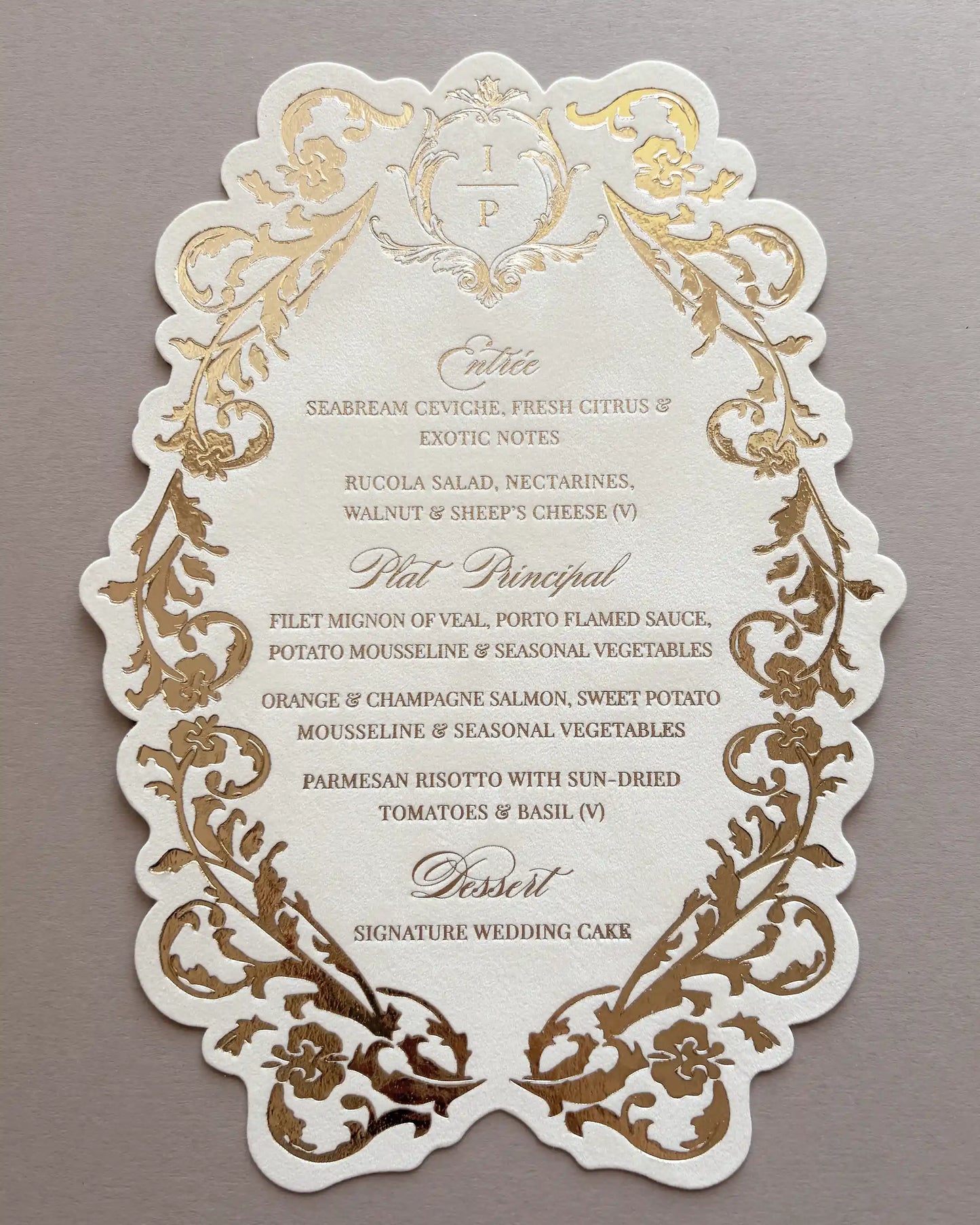 Full view of Belle wedding menu with scalloped edge, gold foil-pressed baroque border and monogram crest, printed dinner course details | Polina Perri